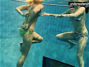 two luxurious amateurs showing their figures off under water